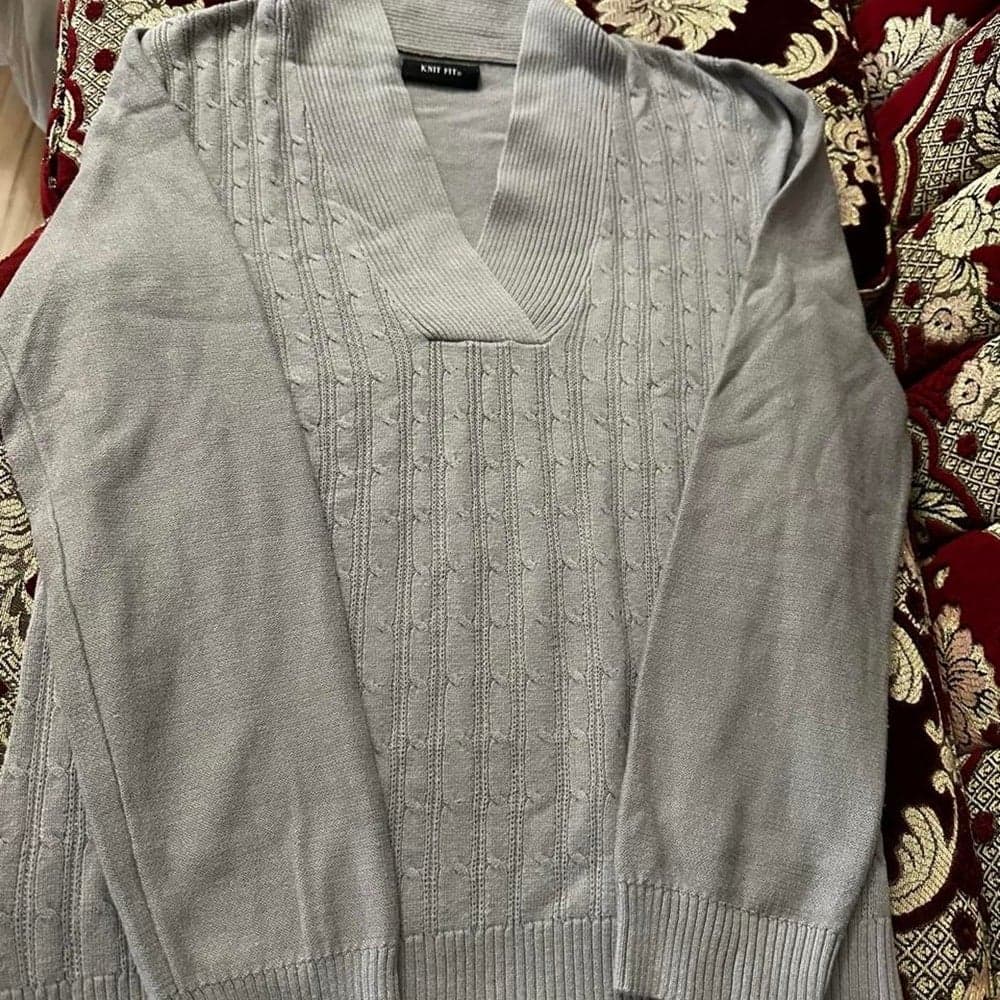 Gray cable knit sweater with ribbed texture