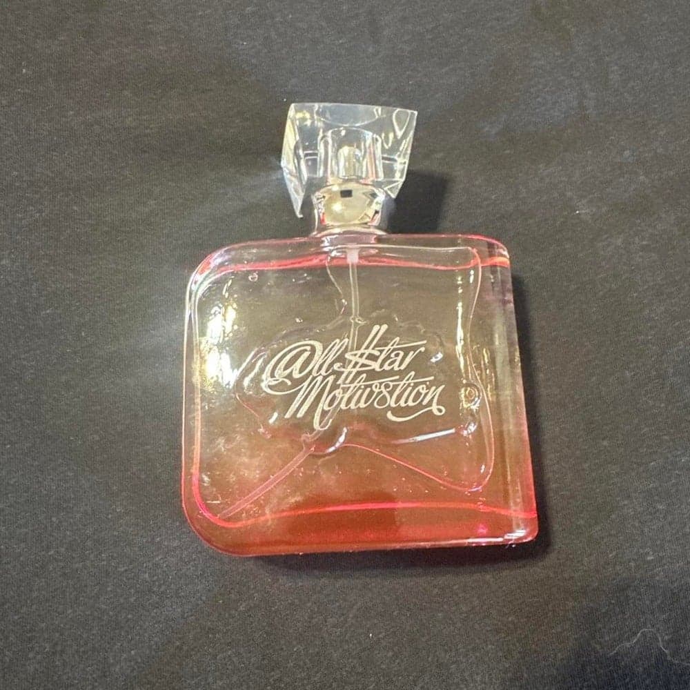 All Star Motivation perfume bottle with pink liquid